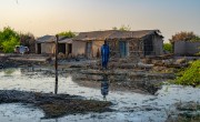 Man standing among damage caused by Pakistan floods