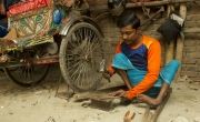 Ferdous Biswas working in his rickshaw garage in Bangladesh