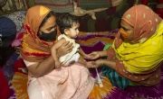 Jhumur Akter Moni receiving nutrition service from Shikha for her daughter Tasmia