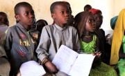 Schoolchildren in Chad holding workbooks
