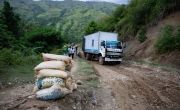 Market access for food producers and consumers in Haiti is made more difficult by poor road infrastructure. Here a truck attempts to negotiate a bad stretch of road in Centre province after its cargo had been unloaded to reduce weight. Photo: Kieran McConville/Concern Worldwide