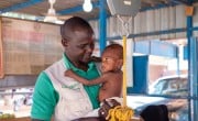 Concern's Early-Child Development Officer Mahamadou Boubakar helps healthcare staff at the Concern-supported intensive nutritional recovery centre (CRENI) at Tahoua Hospital carry out an initial assessment of 13-month-old Nana-Aicha who is severely malnourished. (Photo: Darren Vaughan/Concern Worldwide)