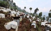 A camp in DRC for internally-displaced persons (IDPs). The camp is built on ground made of broken volcanic rocks, and heavy rains almost daily leave the ground muddy and wet, making it inhospitable and sometimes impassable for people using crutches or wheelchairs. (Photo: Concern Worldwide)