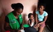 Michaelle Appolon of Concern Worldwide in Haiti interviews Felicie Jeune and her daughter Celise Jean Baptiste at their home in Cité Soleil, Port-au-Prince. The family participates in the USAID-funded Manje Pi Byen program.
