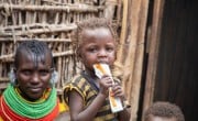 In Kenya, 19-month-old Midina eats a packet of RUTF. (Photo: Gavin Douglas/Concern Worldwide)