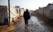 Jaafar* (32) walks through the muddy roads of Ahl al-Khair camp “The condition here is very harsh and staying in a camp is difficult, we did not have any happy occasions in the camp nor any joyful occasion. Do not think that whoever stays here will be happy "This is not true. Anyone who lives here is forced to do so." Photo: Ali Haj Suleiman/DEC/Fairpicture