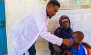 Ahmed Sahane Mohammed, nutritionist at West Imi Health centre provides supplementary food to Tadalesh who had just been diagnosed with malnutrition.