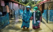 A Concern team member walks with a flood affected woman 