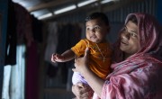 Baby Taybatul Jannat giggles as her mother holds her