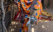 Mahadia Gamar demonstrates the peanut grinder she bought with Concern's support. She earns extra income grinding nuts for other women in her community. Photos: Eugene Ikua/Concern Worldwide