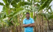 Raza Mia (35) stands proudly in his banana farm, a smile on his face. By planting banana trees along the canal that runs beside Raza Mia’s home in Kajiyar Char, he has not only prevented the canal from expanding due to the flow from the Teesta River but also created a source of bananas to eat, share, and sell, setting an example for others. Photo: Saikat Mojumder/Concern Worldwide