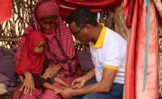A mother-to-mother support group programme participant and her daughter in Dollo, Ethiopia recieve a health check. The aim of the group is to improve child health and empower mothers to manage their childrens nutrition effectively. Photo Adnan Mohamed Afar/Concern Worldwide.