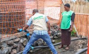 Staff in Democratic Republic of Congo clean tanks at the water pumping station built and maintained by Concern at a displacement site in North Kivu. Photo