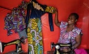 Alice at the shop she was able to start in part through her participation in a Concern-led VSLA. With a loan from her VSLA, she began to sell fabric, and she's also teaching others to sew so they can start their own shops. Photo: Eugene Ikua / Concern Worldwide