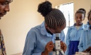 Student Midina Tura looks through a microscope during an integrated science class at Bubisa Junior Secondary School, Marsabit, Kenya. Photo: Eugene Ikua/Concern Worldwide