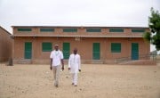 Ibrahim* with a Concern Niger staff member walk through a series of classrooms refurbished by Concern as part of the Learning Together programme. Photo: Concern Worldwide