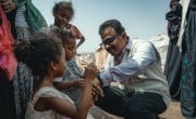 Concern’s Yemen Country Director Victor Moses chat to children in a displacement camp in Yemen