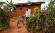Theogene Niyogisubizo (18) earns an income through farming and beekeeping. He is a member of a local savings association, through which he has been able to buy a bicycle, rent more land, and hire people to work for him. Theogene has been able to make repairs to his house and helps support his younger brother in school. Photo: Eugene Ikua/Concern Worldwide