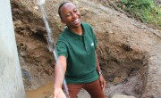 Gloria Kafuria, Concern Worldwide water and sanitation engineer, at a solar water system that she designed. The tank, which holds 25,000 liters, delivers safe drinking water to as many as 3,000 people a day Photo: Crystal Wells/Concern Worldwide