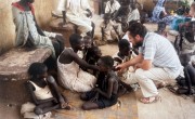 Concern Field Director Tom Lavin in southern Sudan, 1988, talking to civilians displaced by conflict waiting at a concern feeding center.