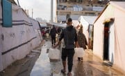 A man carries water containers in Gaza