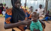 Ayaan* (30) feeds her son Malual* (18 months) therapeutic food at Lueth Ngor Public Health Care Unit in Aweil North, South Sudan. Concern's work in the clinic is funded by Irish Aid. Photo: Eugene Ikua/Concern Worldwide