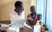 Dominic Dut, the Clinical officer at the Irish Aid-funded Lueth Ngor Public Health Care Unit attends to Adut* (25) and her baby Axlam* (18 months). Photo: Eugene Ikua/Concern Worldwide