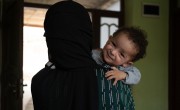 Malalai* holds baby Hafez* at a Family Health House near her home in Takhar Province. Hafez faced multiple health problems after he was born, and his parents have found answers and treatment at this Concern-supported clinic. Photo: Nava Jamshidi/Concern Worldwide