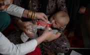 A Family Health House midwife in Takhar Province feeds Tahira*'s infant son, Faris*, ready-to-use therapeutic food (RUTF) as part of his treatment for malnutrition. Photo: Nava Jamshidi/Concern Worldwide