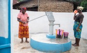 Two women at community water pump in Sierra Leone