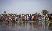 People wait for an emergency cash distribution following a devastating flood in Unity State. Photo: Ed Ram/Concern Worldwide