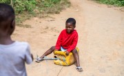 Ramatu Bangura playing on jerry can