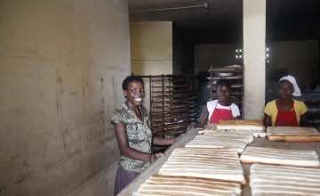 Christela Louis inside the bakery, supported by Concern, where she has worked since May. Christela is confident that through working here, she will be able to grow her business and start saving money. Photo: Kristin Myers / Concern Worldwide.