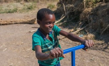 Liven, 13, uses the treadle water pump that Concern provided to his mother