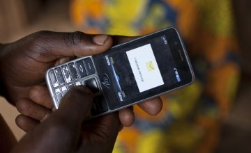  Olivier Irankunda (23) uses his mobile phone at his home in Mabayi, Cibitoke.