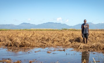 Patrick Ghembo of Monyo Village, Malawi, standing in his field, destroyed by floods. Photo: Concern Worldwide.