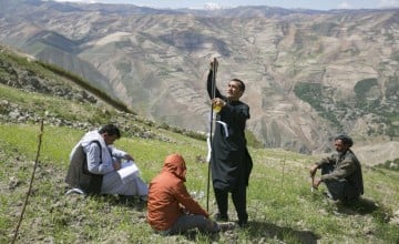 Setting measuring posts to gauge land slippage on a hillside in Yawan. Photo: Kieran McConville / Concern Worldwide. 