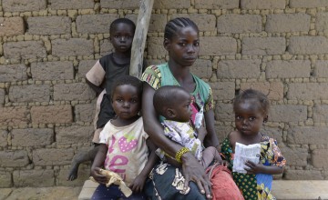 Golden Marlenue, 27 outside her home with her young children. Her two youngest children Naomi, two and Athanase, 12 months, are both malnourished. Photo: Chris de Bode/Panos Pictures for Concern Worldwide