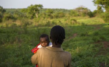 Natalie Wato (33) with her five-week-old son Sauvenator on the small plot of land the family tends near their home. Photo: Chris de Bode.