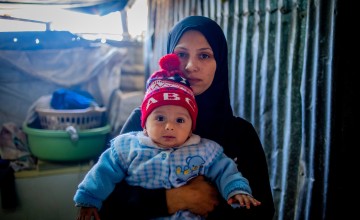 A Syrian woman pictured with her baby.