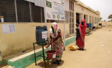 To help reduce the spread of Covid-19 beneficiaries wash hands before entering Concern supported Nutrition Facility in West Darfur.