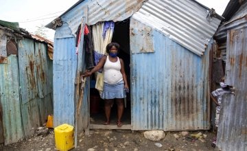 Louismene pictured outside the home she shares with her children four children in Cite Soleil slum, a district of Port-au-Prince, Haiti. Photo: Dieu Nalio Chery