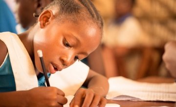 A Class 3 pupil at Baptist Rowalla Primary School, in Tonkolili, Sierra Leone, engages in a literacy exercise, 2014. Photo: Michael Duff / Concern Worldwide.