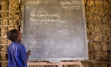 An SLMB Masaba Primary School pupil engages in Literacy, Kunike Barina in Tonkolili, Sierra Leone, 2014. Photo: Michael Duff / Concern Worldwide.