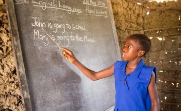A pupil at SLMB Masaba Primary School, Kunike Barina Chiefdom in Tonkolili, Sierra Leone, engages in a literacy class, 2014. Photo: Michael Duff / Concern Worldwide.