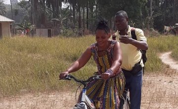 Influential Woman in Sierra Leone having a cycling lesson.