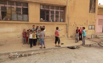 Children playing in their new home which is an abandoned school in Syria. Photographer: Arjan Ottens