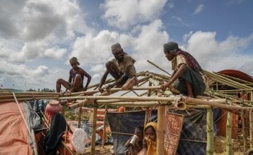 Rohingya men rebuilding their tents before the monsoon arrives. 