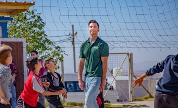 Dublin footballer Michael Darragh Macauley playing volleyball with Syrian children in Iraq