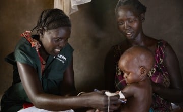 Concern Community Health Worker Rebekah visits Nyariemi Gony and her son.
